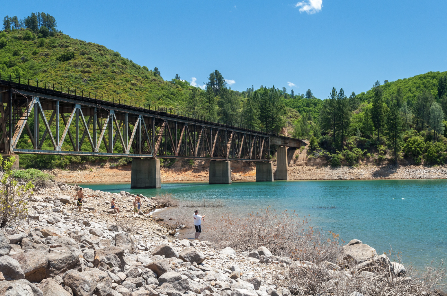 Shasta Lake shoreline near Lakehead with railroad trestle bridge